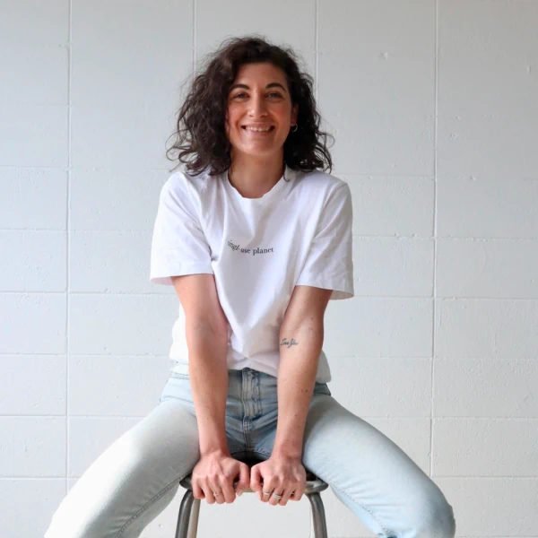 A smiling woman sitting on a chair.